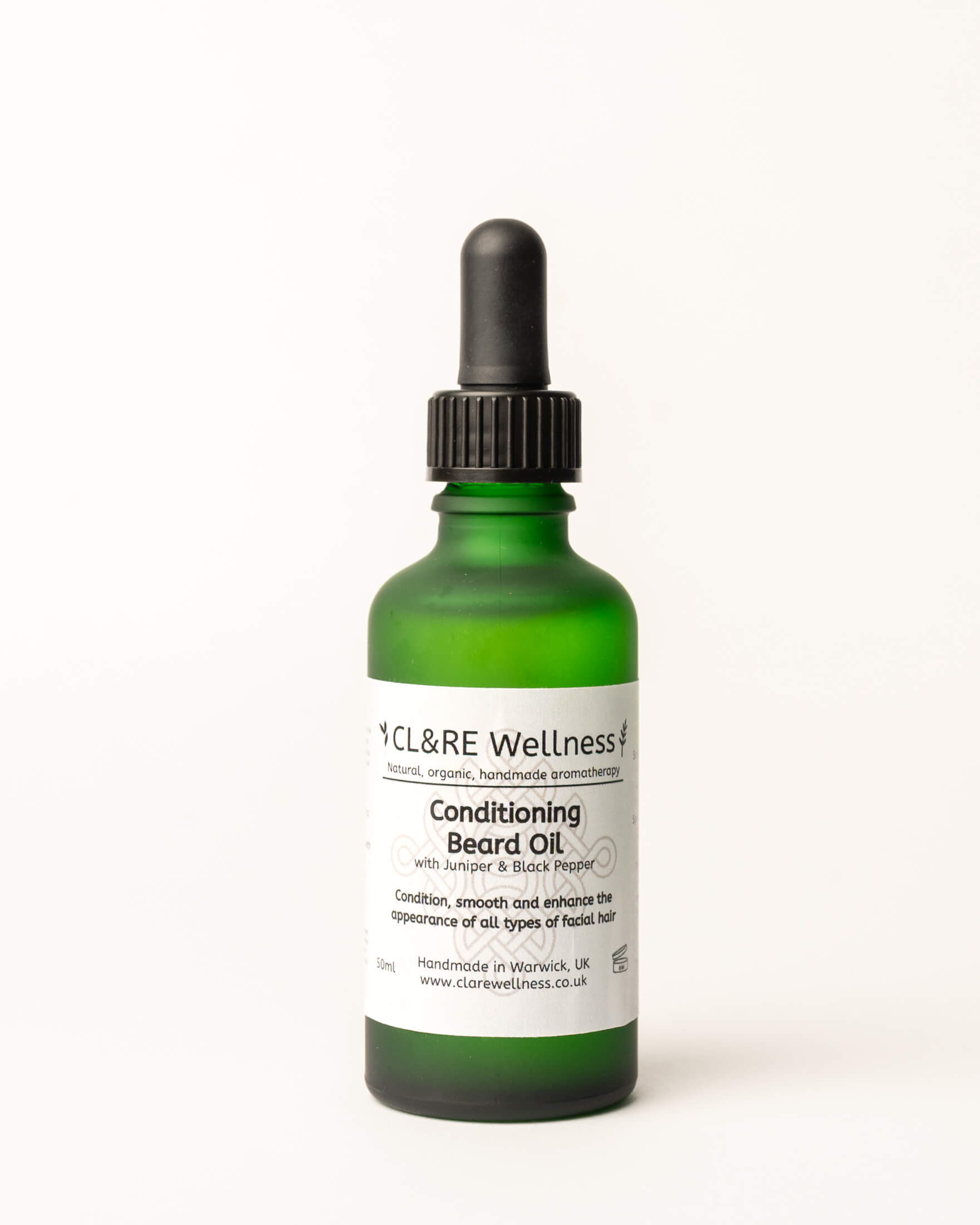 Green bottle of CL&RE Wellness Conditioning Beard Oil on a white background