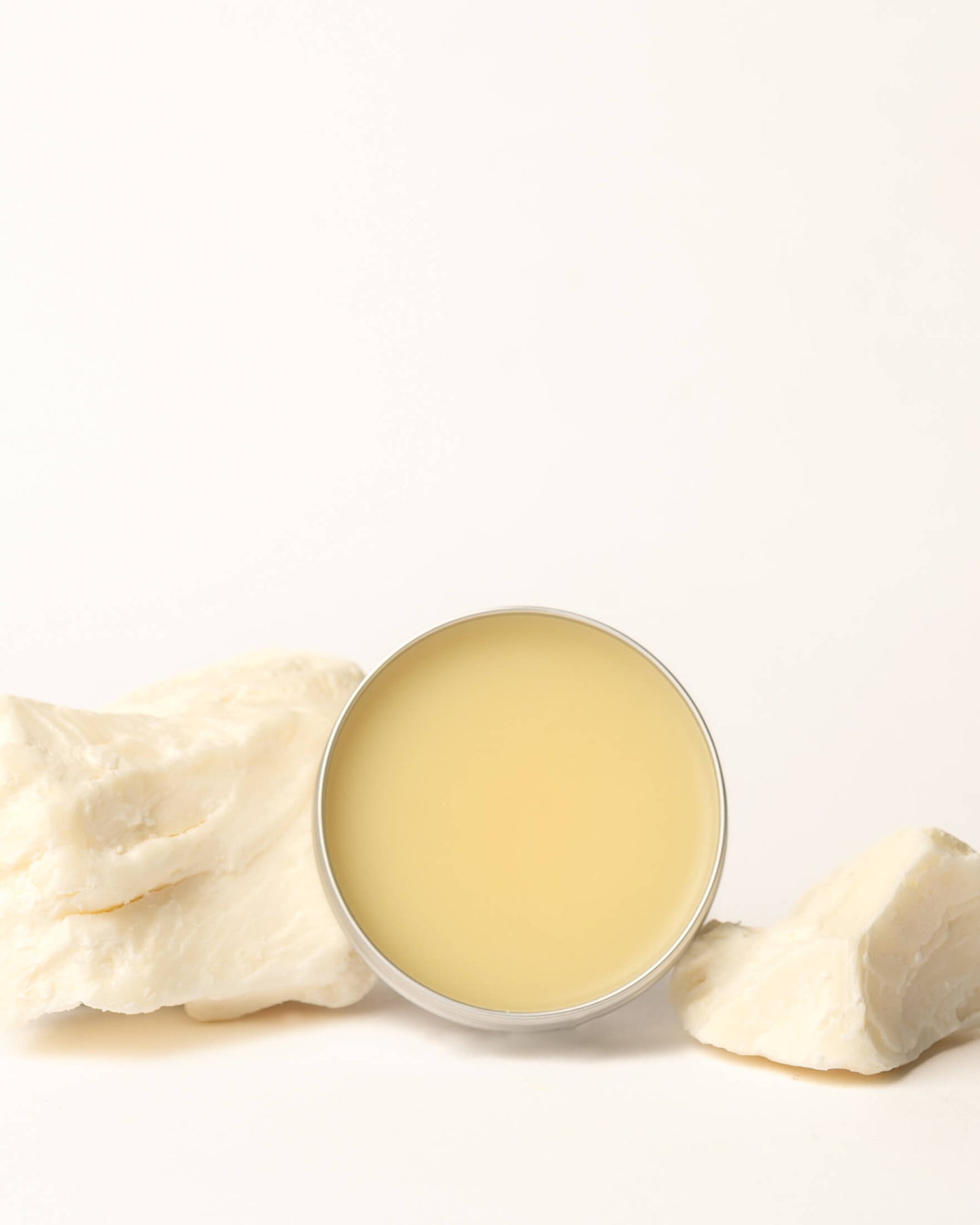 Balm in a round container with a white background