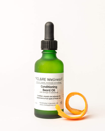 Green bottle of CL&RE Wellness Conditioning Beard Oil with a dropper on a white background