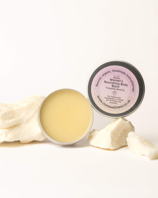 CL&RE Wellness Womens Nourishing Balm with a container on a white background with some small chunks of natural butter alongside it.