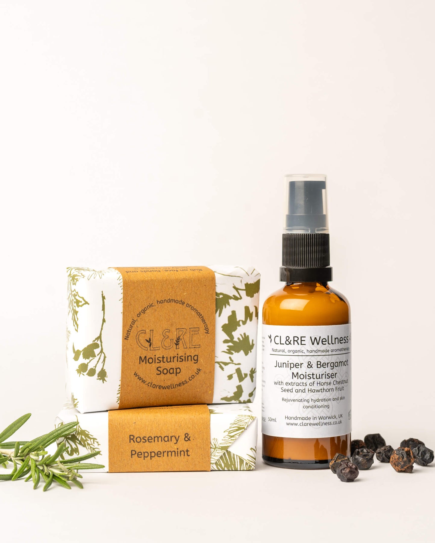CL&RE Wellness products including a Facial Moisturiser with Juniper & Black Pepper and two bars of moisturising Rosemary & Peppermint Soap on a white background
