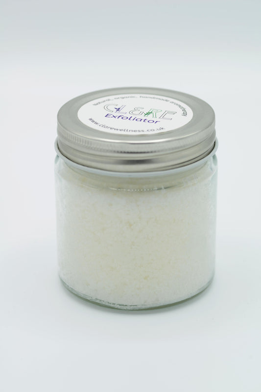 A jar of Coconut Exfoliator with lavender essential oils. The jar has a CL&RE Wellness label on the lid.